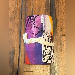 Canvas cloth roll-up pencil organizer filled with a set of colored pencils